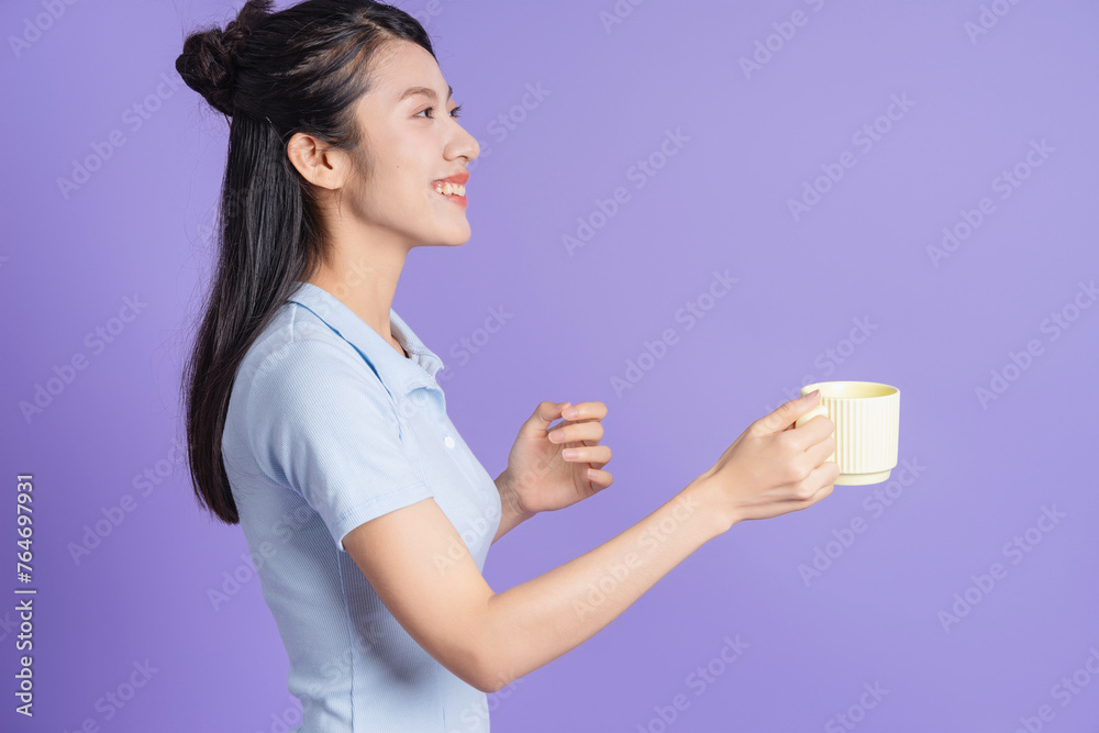Photo of young Asian girl on purple background Photo of young Asian girl on purple background
