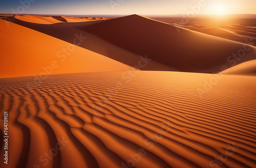 A huge desert and sand dunes against the background of the warm sun. Beautiful background of nature and desert