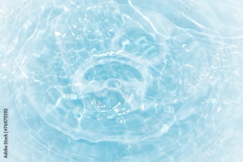 Bluewater waves on the surface ripples blurred. Defocus blurred transparent blue colored clear calm water surface texture with splash and bubbles. Water waves with shining pattern texture background. © Water 💧 Shining 📸