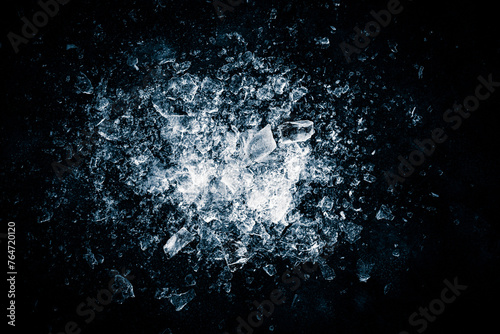 Ice, crushed on a black background. Shards of crushed ice spreading away. The explosion of ice.