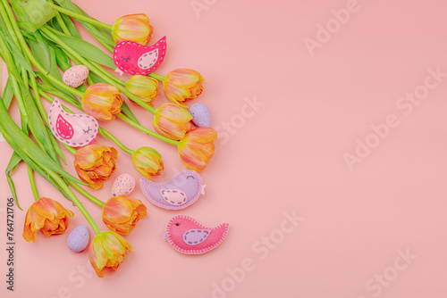 Gentle Easter composition with tulips flowers and handmade felt birds. Traditional elements