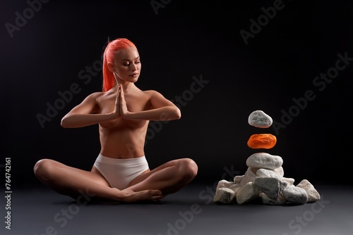 Topless woman meditating and making gesture of mudra