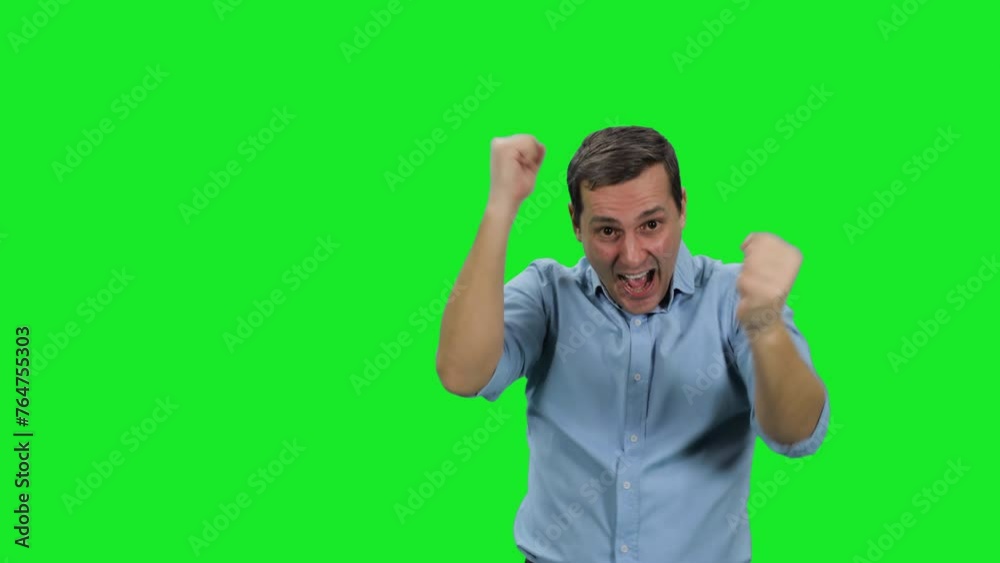 Young happy business man winner celebrating success showing hands gesture yes on green background Young happy business man winner celebrating success showing hands gesture yes on green background
