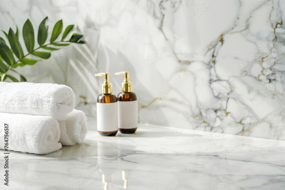 Spa treatment accessories, towels and cosmetic bottles on marble table