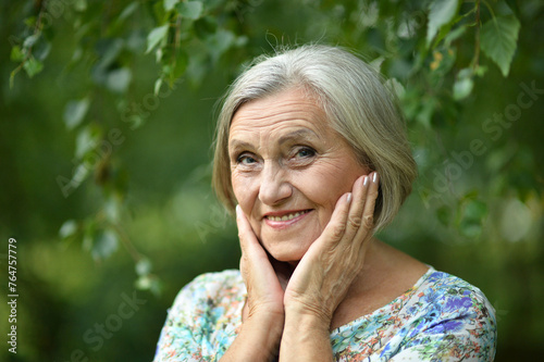 Portrait of senior woman in summer park