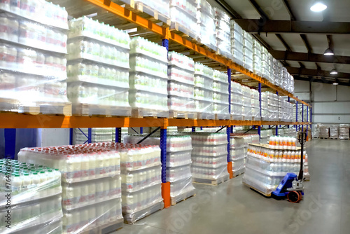 Billede på lærred Large warehouse with goods on shelves of racks.