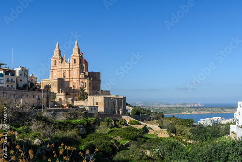 Mellieha, Malta - December 25th 2022: The valley overlooked by the Parish Church of the Nativity of the Virgin Mary with Mellieha Bay in the background.