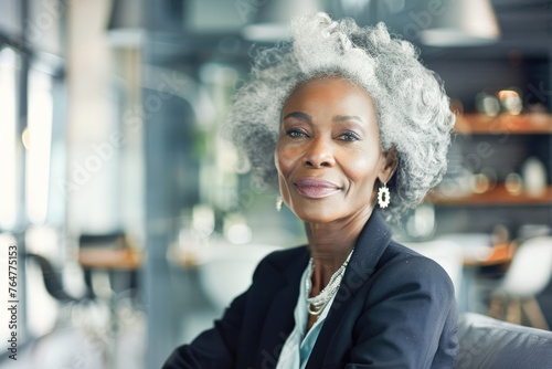 Portrait of a senior confident businesswoman ceo standing in office. Positive successful female entrepreneur posing with arms crossed. Concept of successful businesswoman. 