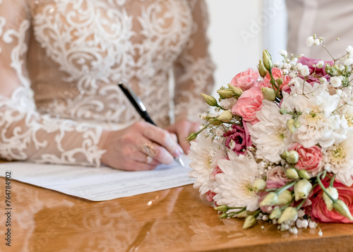 The bride signs the marriage certificate © PumpedVisuals