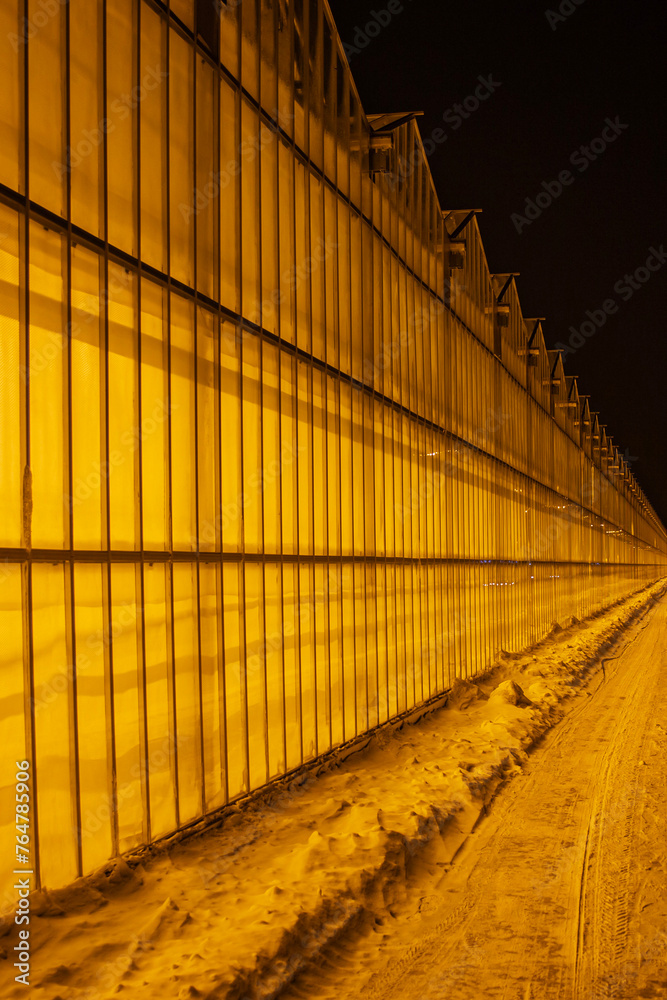 view of the greenhouse from the outside, all shining against the backdrop of snow and frosty night, providing strategic supplies of vegetables view of the greenhouse from the outside, all shining against the backdrop of snow and frosty night, providing strategic supplies of vegetables