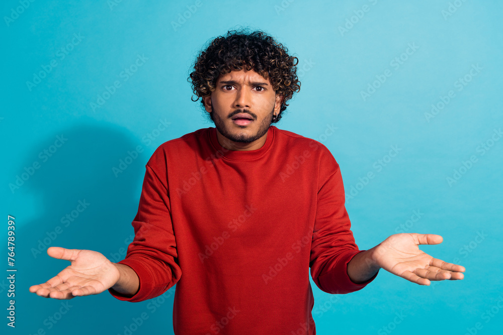 Photo of questioned speechless guy raise hands stare cant believe isolated on blue color background - obrazy, fototapety, plakaty 