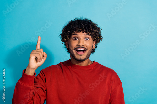 Photo of clever creative person point finger excellent brilliant idea isolated on blue color background