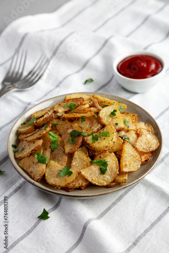 Homemade Roasted Garlic Parmesan Potatoes on a Plate, side view.