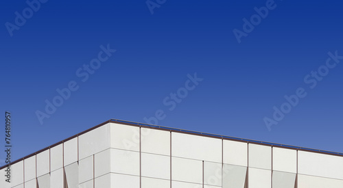 Top edge of a modern building and blue sky