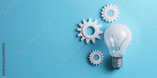 Light bulb and gears on blue background, concept of ideas and creativity