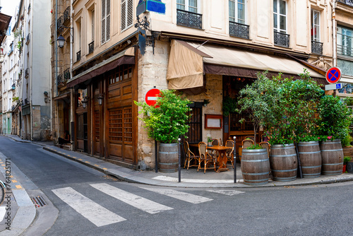 Parisian street with tables with tables of cafe in Paris  France. Architecture and landmark of Paris. Cozy Paris cityscape