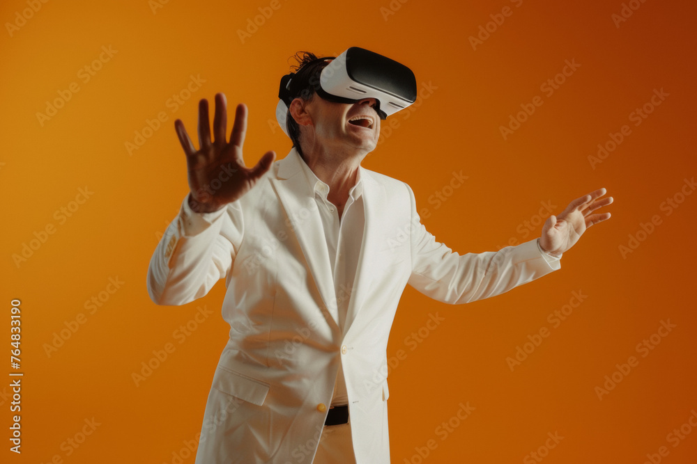 Man in white suit experiencing Virtual Reality on orange background. Man in white suit experiencing Virtual Reality on orange background.