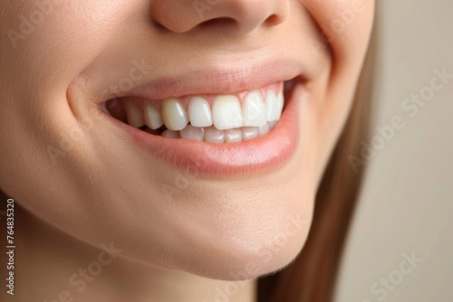 Close-up of a smiling woman showcasing perfect white teeth  denoting health and happiness