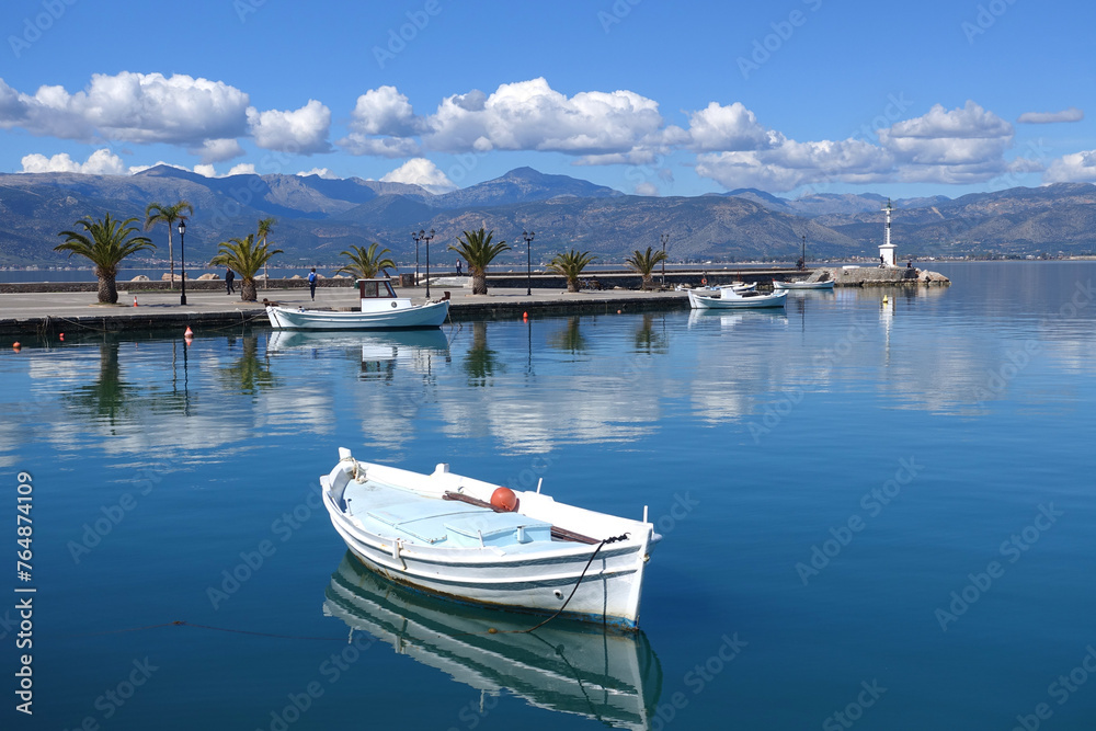 Traditional fishing boats anchored in small port of Nafplio city, Argolida, Peloponnese, Greece Traditional fishing boats anchored in small port of Nafplio city, Argolida, Peloponnese, Greece