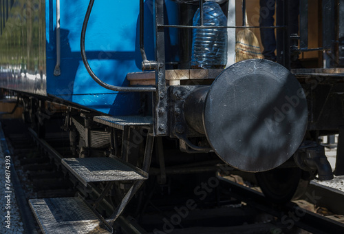 train wagon on rails, blue metal, ladder, entrance to railroad car