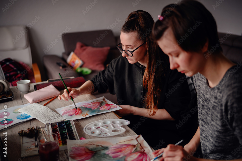 Two artists in sync, immersed in a painting session on a cozy afternoon, their collaboration painting a picture of focused creativity