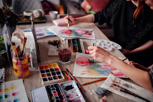 A close-up of an artist's palette and watercolor set, a symphony of hues ready to be transformed into art on paper photo