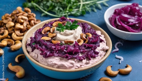 beetroot and cashew dip on a blue table with caramelized onions and vegan mayo. healthy snack or appetizer