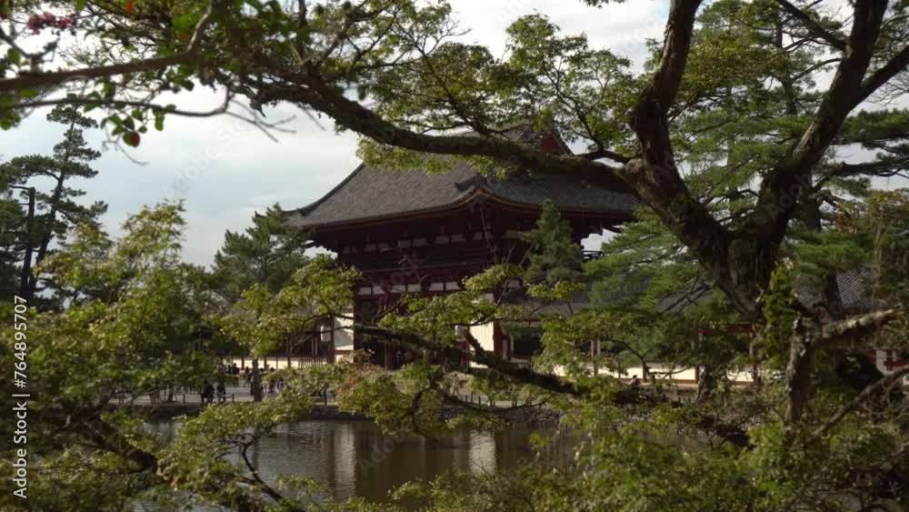 Todaiji Temple (also known as The Great Eastern Temple, one of Japan's most famous and historically significant temples and a landmark of Nara seen Through Trees Todaiji Temple (also known as The Great Eastern Temple, one of Japan's most famous and historically significant temples and a landmark of Nara seen Through Trees