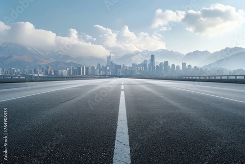 Asphalt road and mountain with city skyline scenery photo