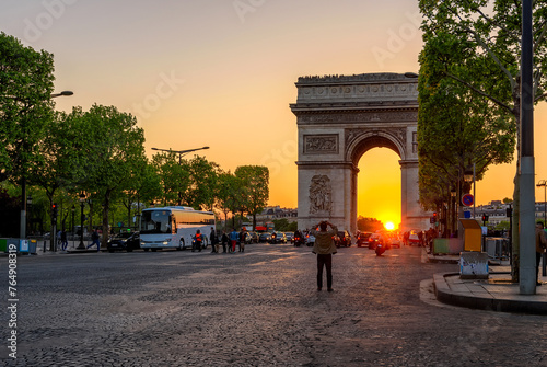 Paris Arc de Triomphe (Triumphal Arch) in Champs Elysees at sunset, Paris, France. Cityscape of Paris. Architecture and landmarks of Paris