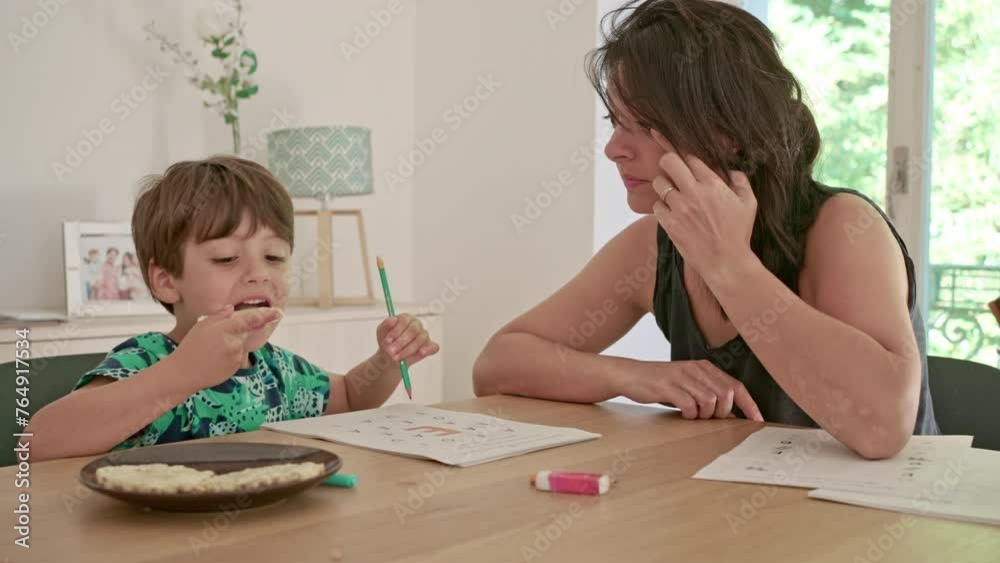 Snack During Studies - Little Boy Eats Cookie To Keep Brain Functioning And Ensure Learning, Shows Signs Of Satisfaction Snack During Studies - Little Boy Eats Cookie To Keep Brain Functioning And Ensure Learning, Shows Signs Of Satisfaction