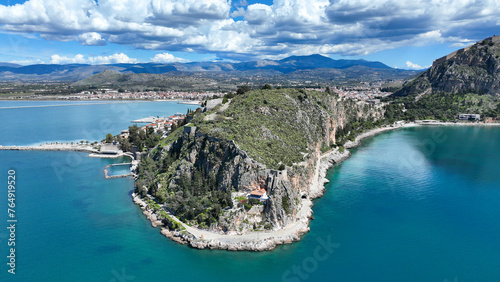 Aerial drone photo of iconic Acronafplia fortress overlooking old city of Nafplio below famous castle of Palamidi as seen in a spring morning with beautiful clouds and deep blue sky, Argolida, Greece photo