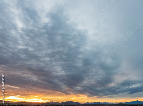 Dramatic Sunset Over Mountain Landscape with Cloudy Sky