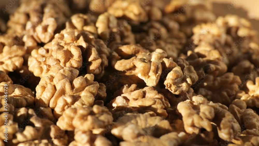 Walnut kernels rotating. walnut close up lies under beams of the sun. Walnut close up. product rich in minerals and vitamins. Macro 4K Walnut kernels rotating. walnut close up lies under beams of the sun. Walnut close up. product rich in minerals and vitamins. Macro 4K