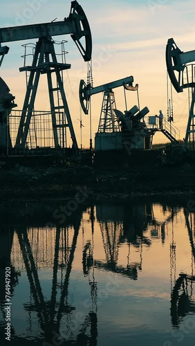 Sunset waterscape with an oil extraction site. Oil industry concept.