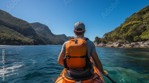Kayaker Enjoying Solitude in a Mountainous Bay © heroimage.io