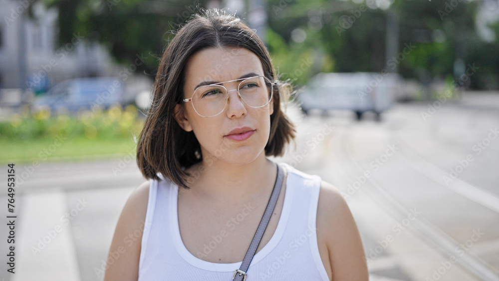 Young beautiful hispanic woman standing with serious expression in the streets of Vienna