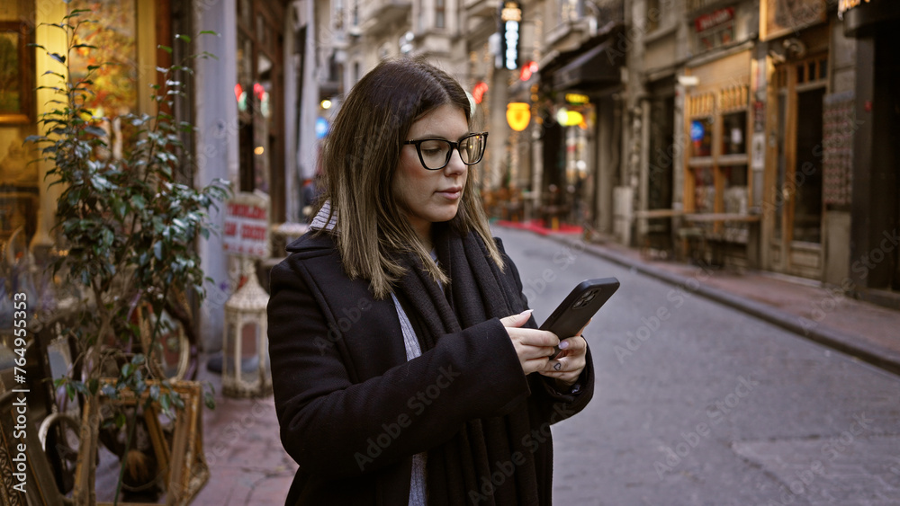 Adult woman browsing smartphone on historic istanbul city street, showcasing travel and urban life in turkey. Adult woman browsing smartphone on historic istanbul city street, showcasing travel and urban life in turkey.