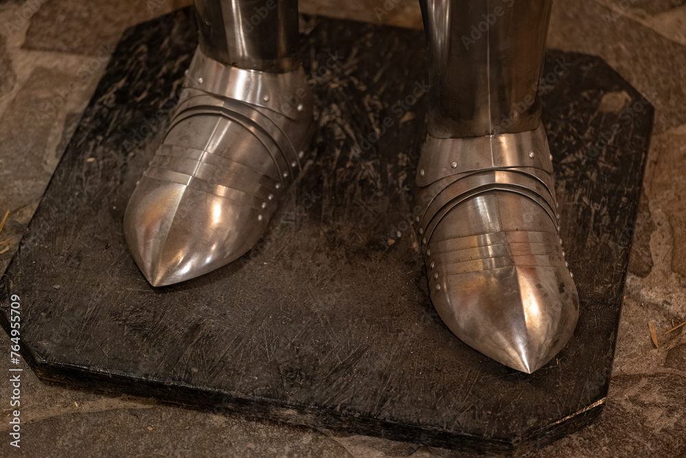 The lower part of the plates to protect the legs of a knight's armor.