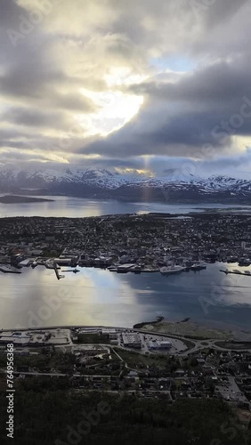 Tromso city in Tromsoya Island as seen from Mount Storsteinen under the Midnight Sun in Norway. photo