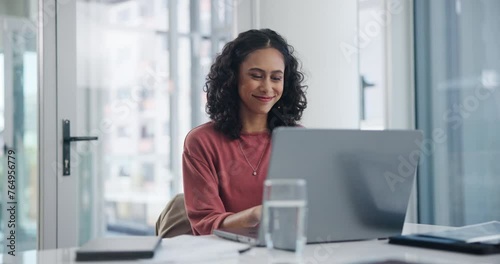 Smile, business woman and typing on laptop on desk at office for email, project or working in startup. Computer, table and professional reading information, blog and creative copywriter with article