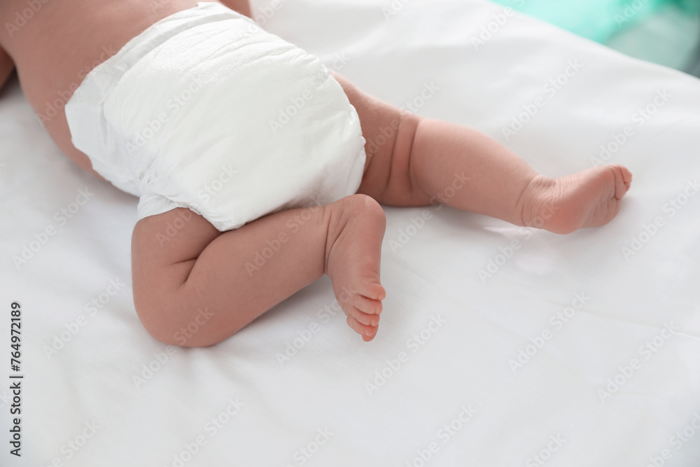 Cute little baby in diaper on bed, closeup Cute little baby in diaper on bed, closeup