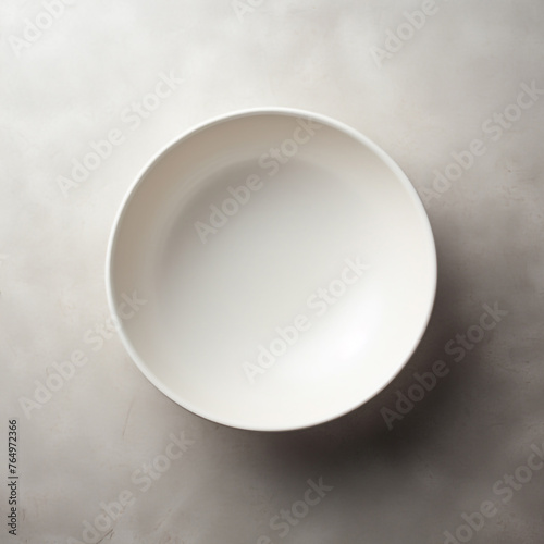 a simple white plate on the table. a place to place the product.