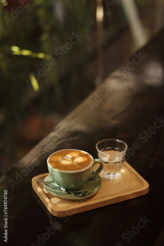 A cup latte art on the wood table