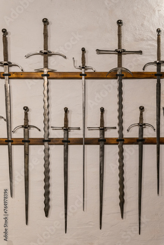 Displayed swords by the wall. photo