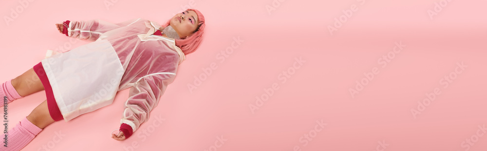 banner of young woman with silver necklace, pink hair and makeup lying down on vibrant background