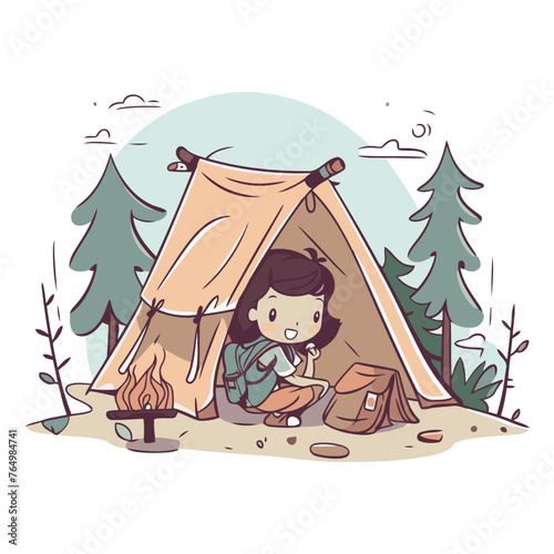 Little boy sitting in a tent in the forest.
