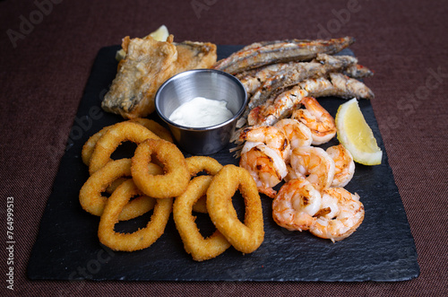 A delicious dish of fried seafood with shrimp, fish, squid and lemon slices
