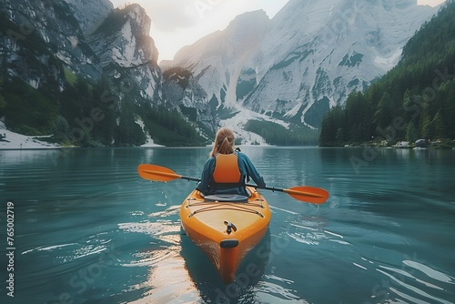Woman Paddling Kayak on Mountain Lake © D