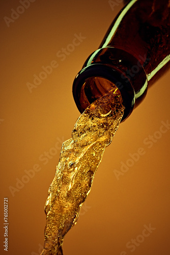 Close-up of beer bottle with chill lager beer pouring against yellow background. Party drink. Concept of alcohol and non-alcohol drinks, refreshment. Poster, banner for ad
